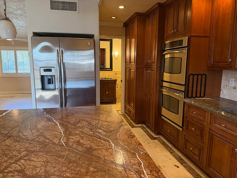 Kitchen view, entry way into downstairs powder bathroom.