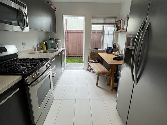 kitchen off living room leads to private backyard