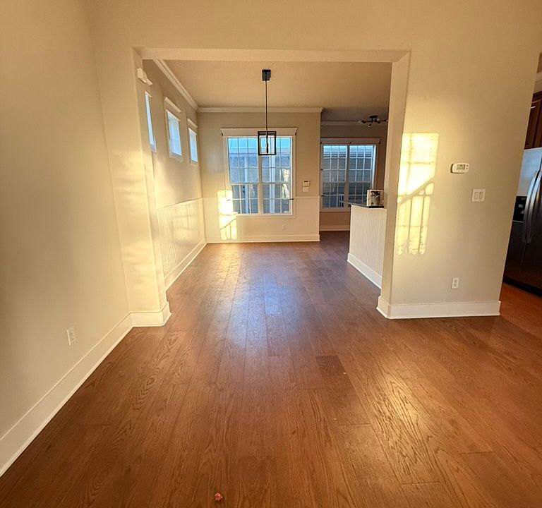 This is the freshly painted living room and dining area with brand new hardwood oak floors!
