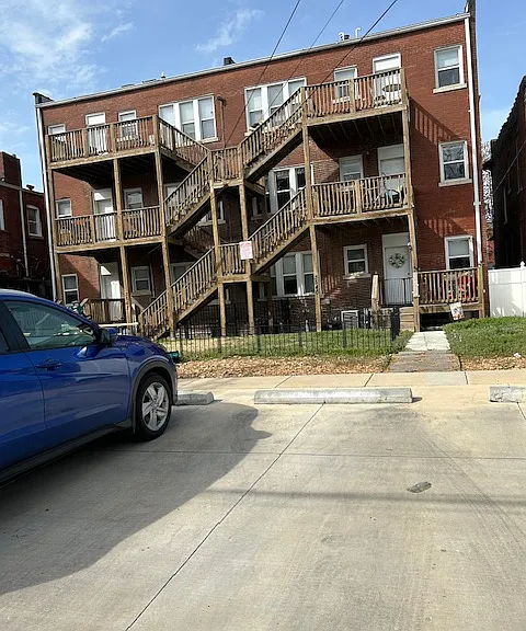 Back of apartment building. This apartment is on the right/east side of the building with covered private deck.