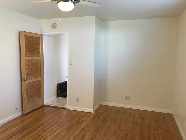 Other view of master bedroom with bonus space where original closet was located.