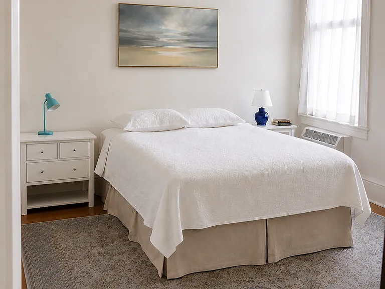 Bedroom with Queen bed, two nightstands, armoire, and built-in closet.
