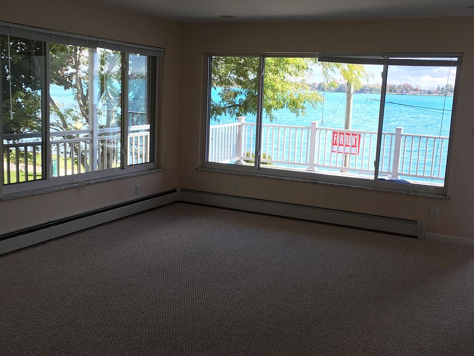 Living room with large windows and views of river & park