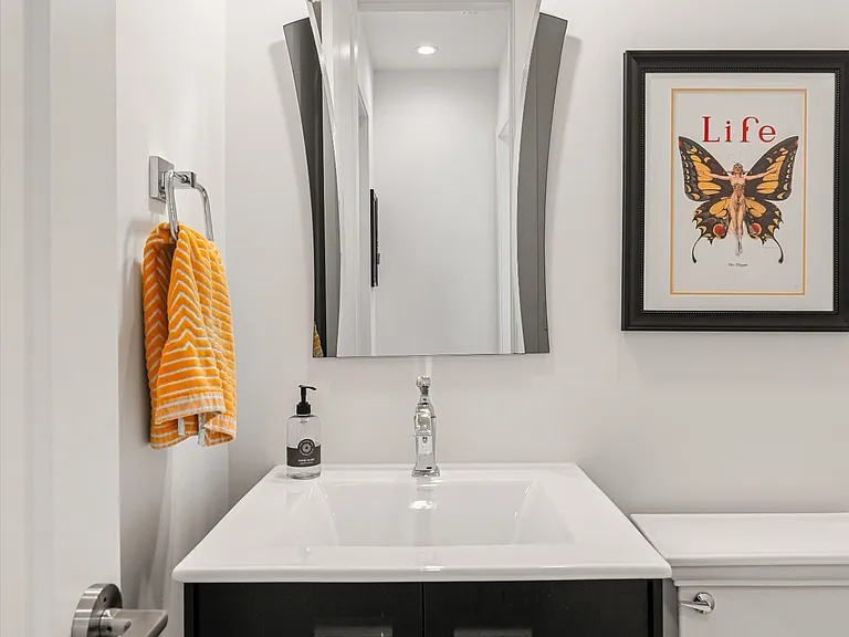 Stylish main-level powder room with modern lighting and designer tile flooring.