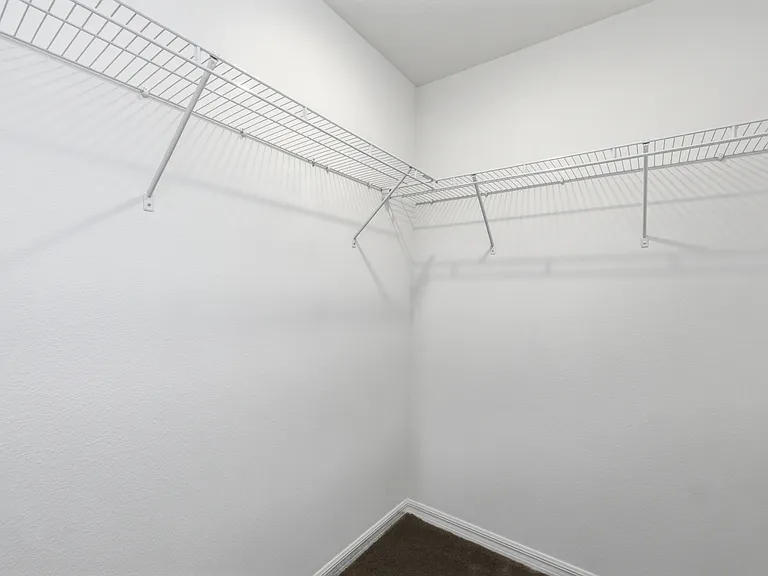 Primary bedroom walk in closet