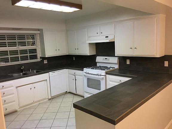 Spacious kitchen with adjacent dining area and patio