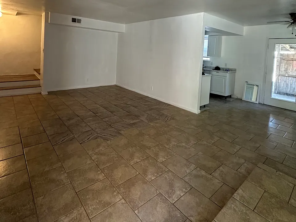 View of living room area from front door, also shown, back door entrance