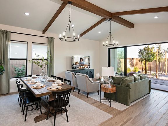 Dining area and great room with stained ceiling beams