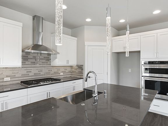 Slab quartz and soft-close cabinets photos are from similar plan and features