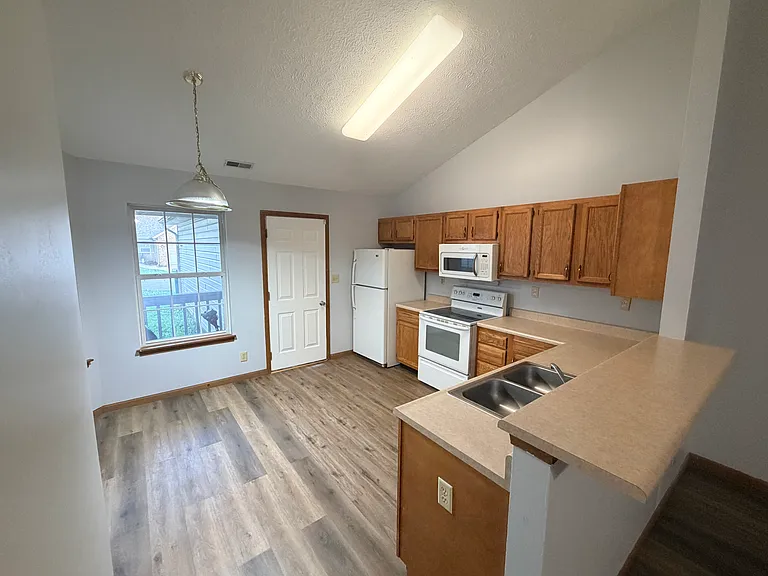 Kitchen and a garage door entrance from the living room view