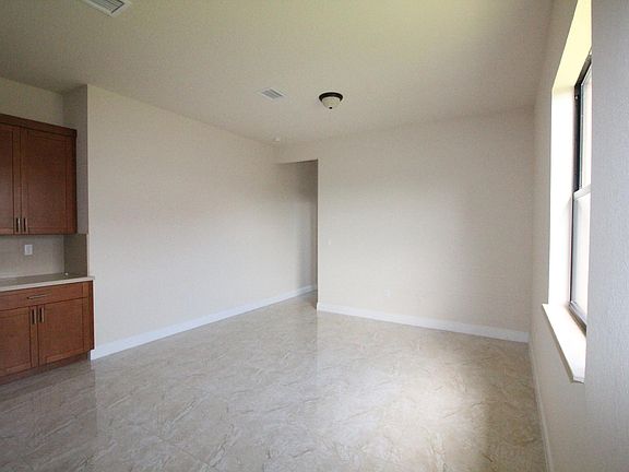 Another view of Kitchenette and Living Room with view of hal