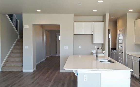 Kitchen features quartz counters, stainless steel appliances and eat-in kitchen
