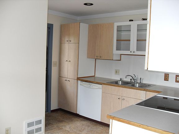 Kitchen (partial).  Refrigerator opposite pantry.