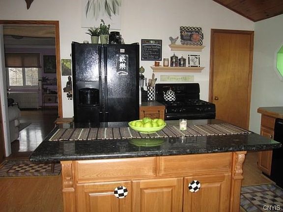 Pretty kitchen. The door to the right leads to a lovely updated bathroom. The opening takes you to the State Street side living room, stairs to the second floor, and the bedroom.