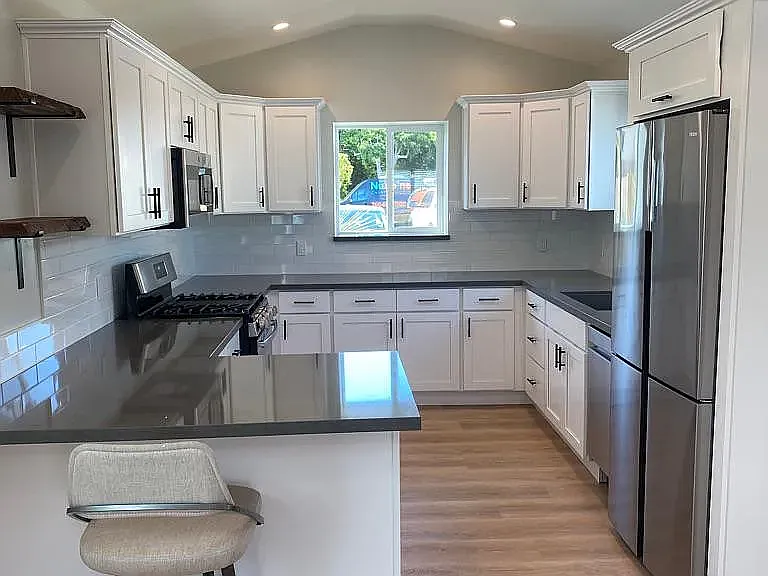 Very generous kitchen, white shaker cabinets, quartz counters includes dishwasher, stainless appliances, eat in bar and plenty of light and bright area to prep your favorite meals.
