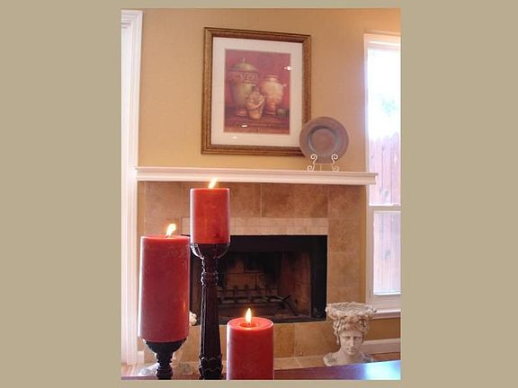 Beautiful fireplace with travertine tile and cultured marble tile