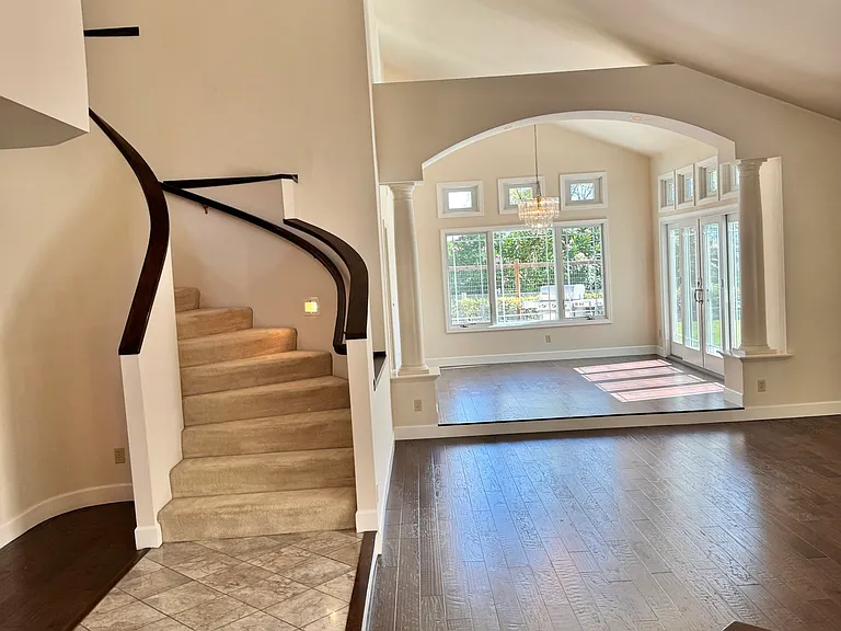 Home entrance opens to an open floor plan with living and dining areas, perfect for entertaining