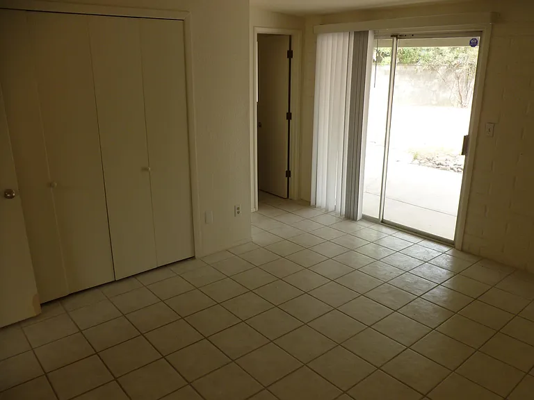Master bedroom with Master bath entrance and exit to patio