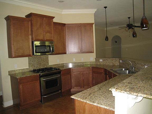 The kitchen has a breakfast bar and lovely cabinetry.