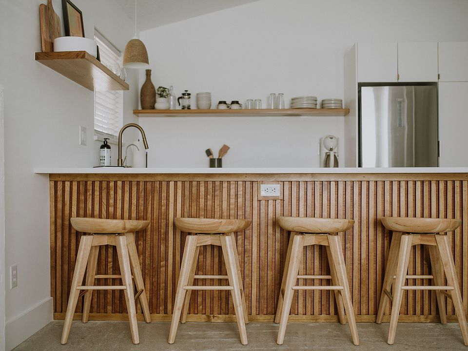 Open concept kitchen with four bar stools.