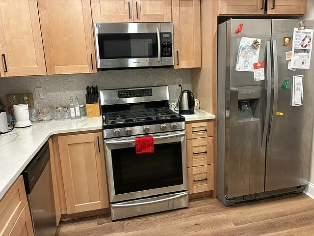 Fully remodeled kitchen. Quartz countertops, bright backsplash, under-counter lighting.