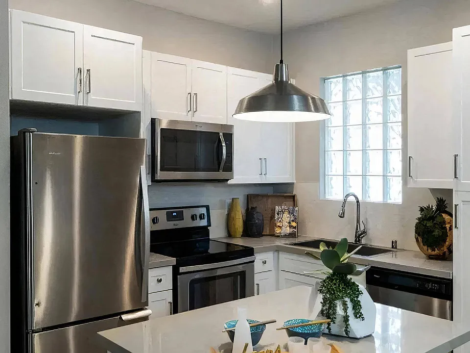 A window above the sink keeps the work counter lit through the day.