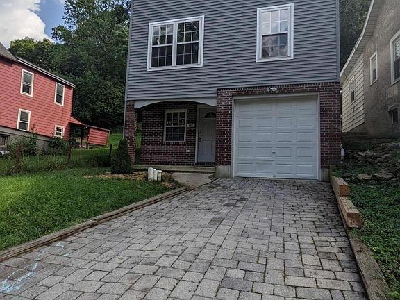 Front of house with three of the bedroom windows and the livingroom area window