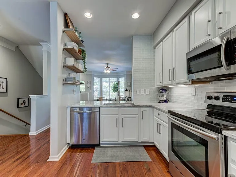 Kitchen, stairs down to entry door and garage.