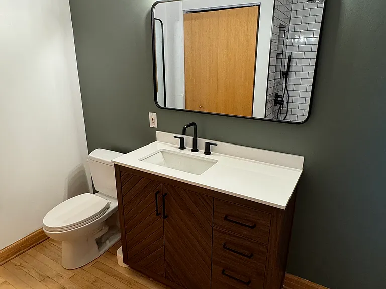 Vanity with stone top, 3 drawers/2 shelves of storage, large mirrors and bright lighting