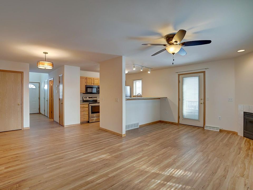 Main floor living room, dining area, and kitchen. Eat-at kitchen bar, gas fireplace, and walk-out to private 10x10 deck