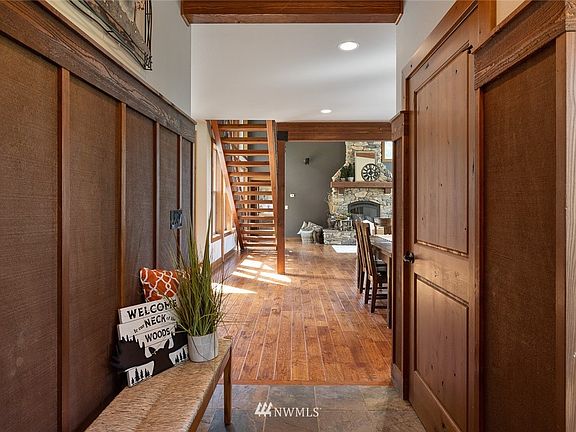 Slate flooring at the entry transitions to gorgeous hand scraped hardwood flooring that is found throughout the entire home, even on the second level.