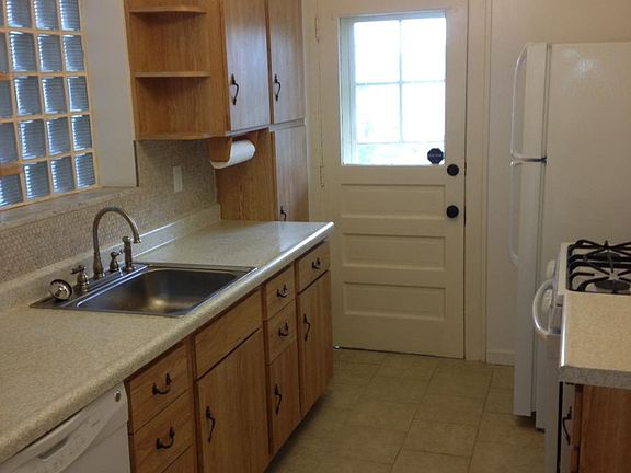 Kitchen leads to stairs down to yard