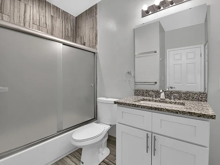 Bathroom - level 2: high-pressure tiled shower/tub, frosted glass by-pass shower doors, granite vanity, vent fan on a timer saves you money!