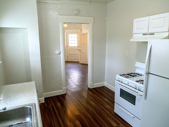 Kitchen with space on left and right for small dining table and/or desk.