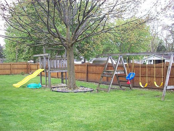Fenced in backyard with play area