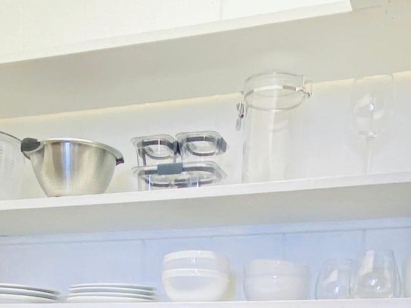wet bar shelves - dinner ware, wine goblets, glasses, coffee cups, salad spinner, strainer, lunch containers, assorted food containers