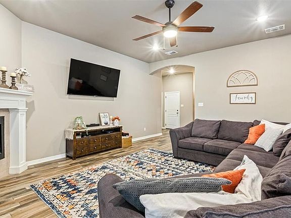 Tile flooring in social area with ceiling fan neutral colors in walls
