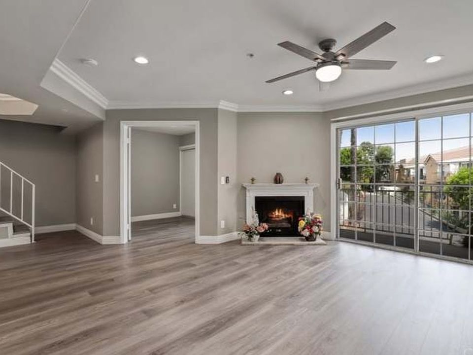 Living room with gas fireplace and balcony