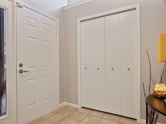 Foyer, open to above, with large window for natural light above coat closet