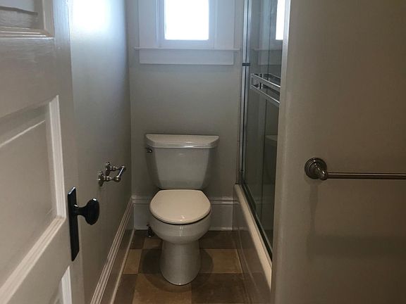 Bathroom, limestone tile, glass sliders on shower