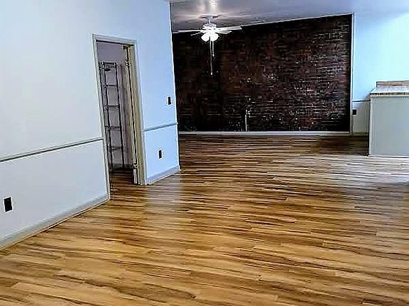 Spacious entrance to living room area with built-in storage