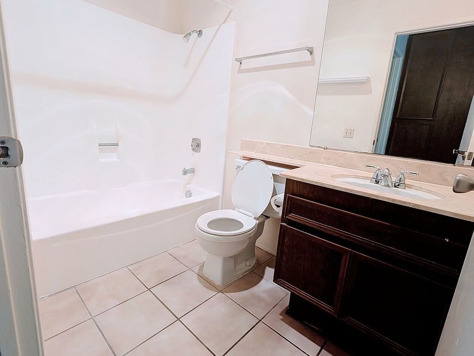 Bathroom has tile floor, storage under sink, and medicine cabinet (not in picture)
