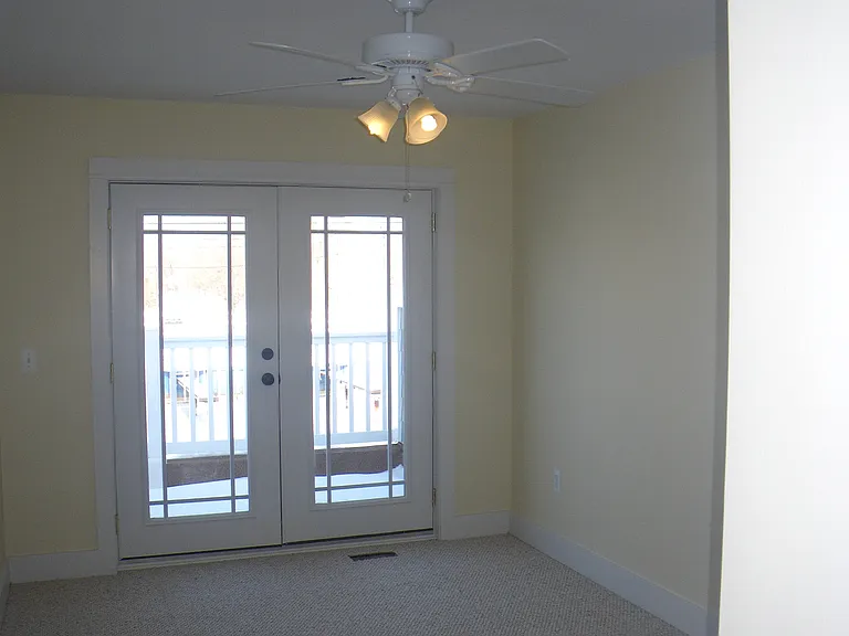 Two bedrooms upstairs with doors opening to the balcony overlooking the canal.