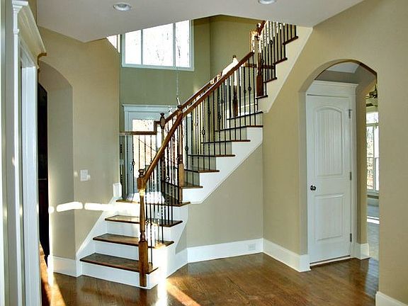 Open double foyer with wrought iron baluster stairway
