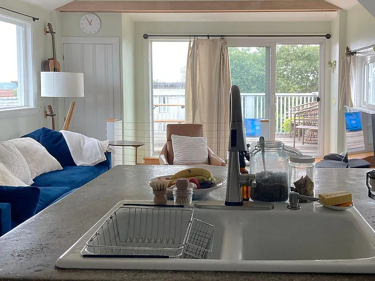 Open kitchen, view toward living area and private deck.