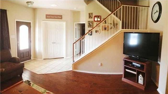 lower level living room view. Office behind the closed door
