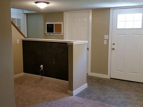 Tiled foyer from entry door, entry closet and attached oversized 2 stall garage door.