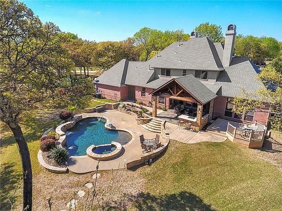 Enjoy the backyard paradise including a huge outdoor living center, built-in grill, deck & Pebble Tec saltwater pool & spa.