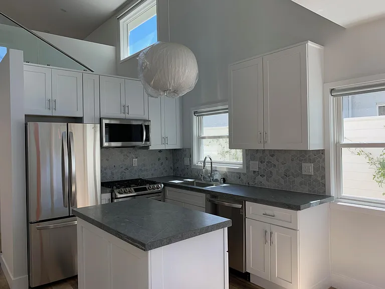 Kitchen has adjacent breakfast nook with picture windows facing south and west.