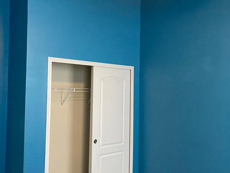 Generous sliding-door closet in second bedroom. ROOM HAS BEEN REPAINTED to neutral color.